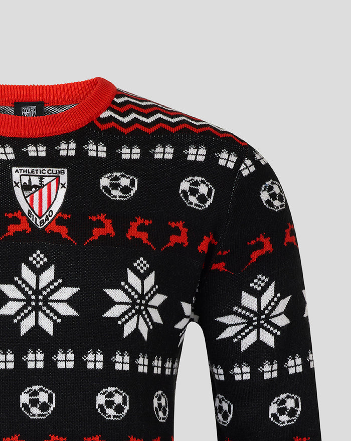 Close up of the Athletic Club Christmas jumper showing the crest on the chest and a knit pattern of soccer balls and snowflakes