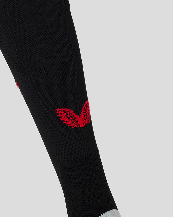 Close up of Athletic Club 4th sock showing red crest on black fabric