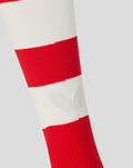 Close-up of a red and white striped athletic sock showing a white logo on the stripe