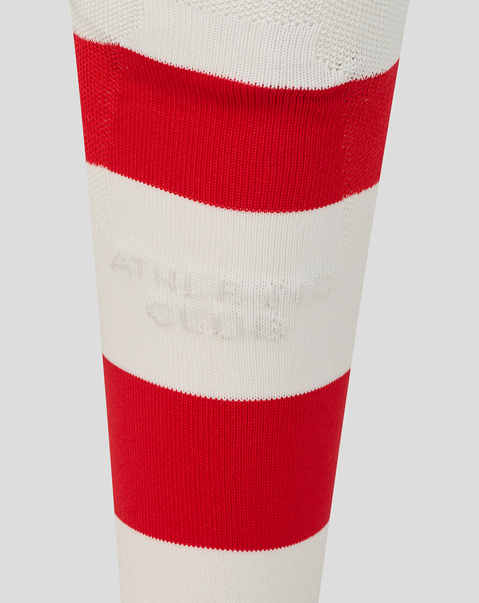 Close-up of a knitted athletic sock with bold red and white horizontal stripes
