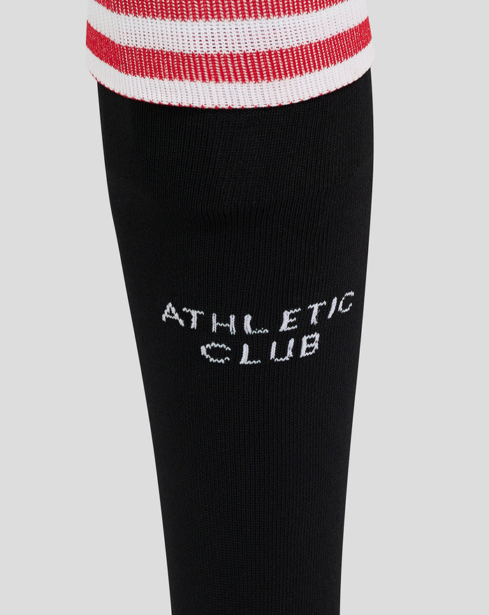 Close-up of shin on black sock showing white Athletic Club wordmark