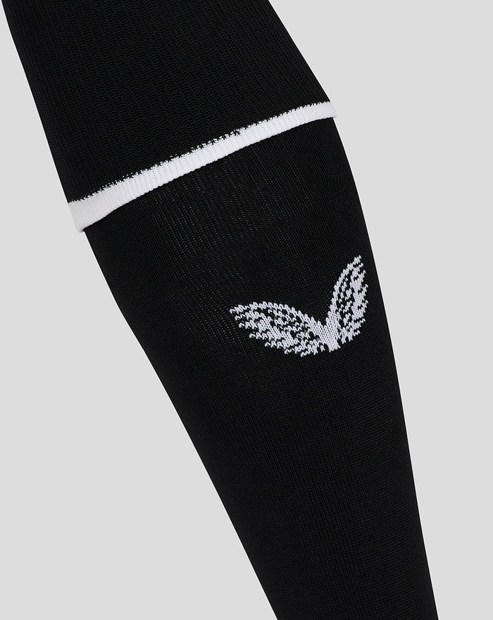 Close up of black goalkeeper sock showing a white top band and the white wing emblem on the shin