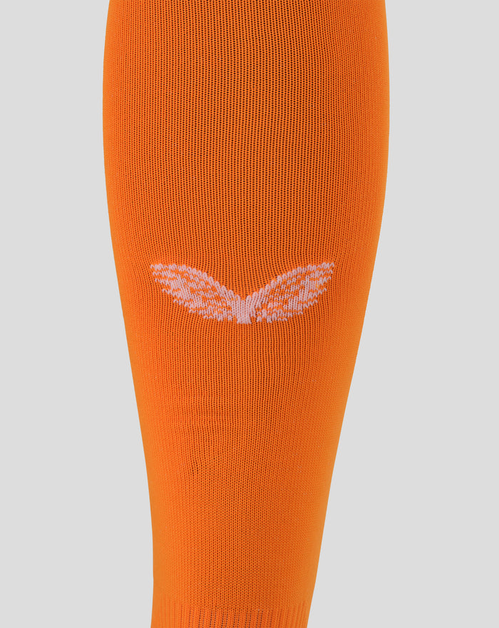Close-up of bright orange footless goalkeeper sock knit with textured weave and light pink chevron detail.