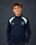 Junior navy performance midlayer top with mint shoulder panels, zip collar, and a club crest on the chest.
