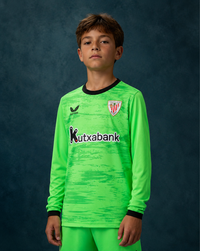 Young player wearing neon green long sleeve goalkeeper jersey with Athletic Club Bilbao crest and Kutxabank sponsor