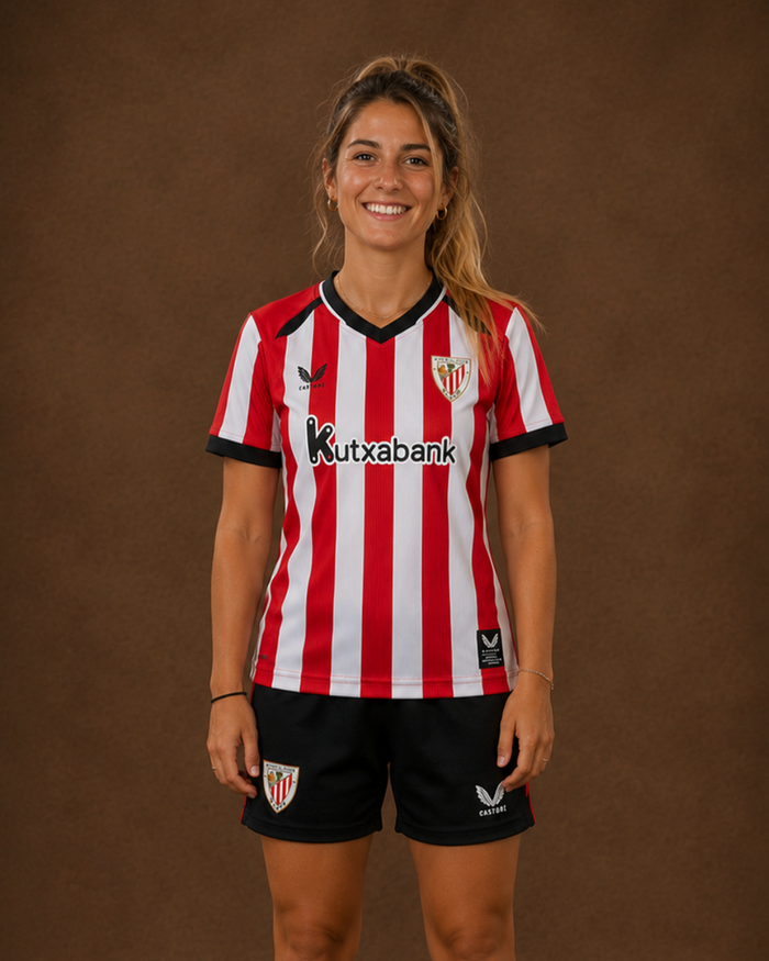 Model wearing the red and white striped 26/27 Home shirt with black shorts