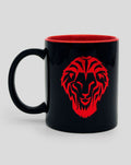 Black ceramic mug with a red lion emblem and red interior.